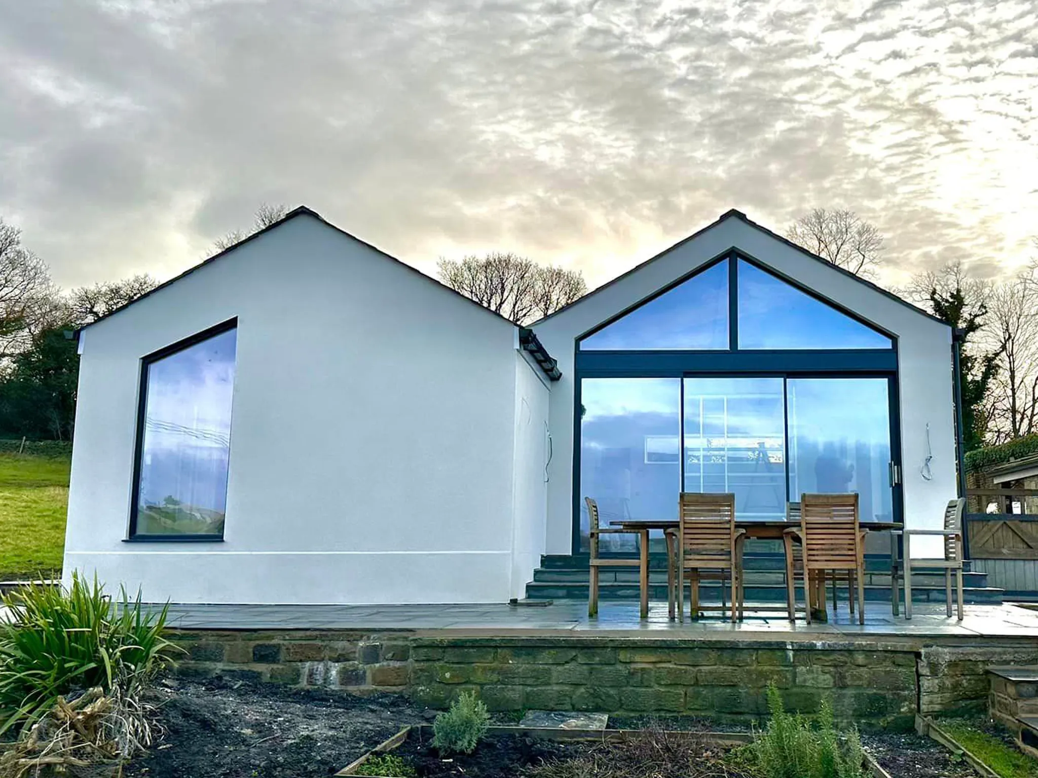 a big white house with 2 pitched roofs